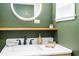 Modern bathroom featuring a stylish vanity with a marble countertop and a round LED mirror at 2711 Crutchfield Rd, Lakeland, FL 33805