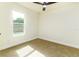 Bright bedroom features a ceiling fan, neutral carpet, and a window providing natural light at 2711 Crutchfield Rd, Lakeland, FL 33805