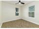 Bright bedroom with neutral carpet, white trim, and windows at 2711 Crutchfield Rd, Lakeland, FL 33805