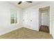 Bedroom features neutral carpet, a window, and two closets, one open to another room at 2711 Crutchfield Rd, Lakeland, FL 33805