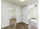 Hallway with hardwood floors leading to the bedroom with carpet and walk-in closet at 2711 Crutchfield Rd, Lakeland, FL 33805