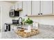 Stylish kitchen with granite countertops, stainless steel appliances, and updated white cabinets at 2711 Crutchfield Rd, Lakeland, FL 33805