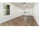 Bright living room featuring hardwood floors, white walls, and natural light from three windows at 2711 Crutchfield Rd, Lakeland, FL 33805