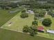 Expansive property featuring lush green pastures, mature trees, outbuildings, and a charming residence at 2911 Walker Rd, Lakeland, FL 33810