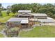 Spacious property features a house, pool, barn, and fenced-in area, surrounded by lush trees and open space at 2911 Walker Rd, Lakeland, FL 33810