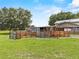 Exterior view of a barn with a fenced enclosure on a grassy field at 2911 Walker Rd, Lakeland, FL 33810