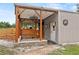 Barn with a covered overhang, stone accents, and adjacent fenced-in area at 2911 Walker Rd, Lakeland, FL 33810