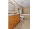 Bathroom with a shower-tub combo, tiled walls, a beige vanity, and neutral walls at 2911 Walker Rd, Lakeland, FL 33810