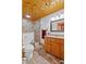 Bathroom featuring wood paneling, tile floors, vanity with a modern shower at 2911 Walker Rd, Lakeland, FL 33810