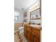 Bathroom featuring wood vanity, patterned tile floor, and a decorative mirror at 2911 Walker Rd, Lakeland, FL 33810