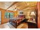 Bedroom featuring wood ceilings and paneling, ceiling fan, and a comfortable bed at 2911 Walker Rd, Lakeland, FL 33810