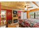 Bedroom showcases wood paneling, a stone fireplace, ceiling fan and a comfortable bed and decor at 2911 Walker Rd, Lakeland, FL 33810