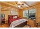 Bedroom features wood paneling, a ceiling fan, and a window with natural light at 2911 Walker Rd, Lakeland, FL 33810