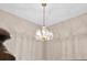 Close up of the elegant, decorative chandelier with crystal accents against a neutral ceiling at 2911 Walker Rd, Lakeland, FL 33810