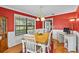 Inviting dining room with a wood table, white chairs, and ample natural light at 2911 Walker Rd, Lakeland, FL 33810