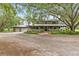 Charming two-story home with a wraparound porch, lush landscaping and detached three car garage at 2911 Walker Rd, Lakeland, FL 33810