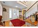 Bright foyer with hardwood floors, staircase, and decorative accents, leading to the rest of the home at 2911 Walker Rd, Lakeland, FL 33810