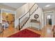 Warm foyer features wood floors, staircase, and an inviting entryway, offering a glimpse into the home's charm at 2911 Walker Rd, Lakeland, FL 33810