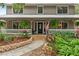 Charming home with a welcoming front porch, American flag, and beautifully landscaped garden at 2911 Walker Rd, Lakeland, FL 33810