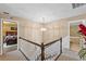 Upper hallway area with decorative chandelier, carpet, and entrances to a bedroom and bathroom at 2911 Walker Rd, Lakeland, FL 33810