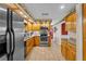 Bright kitchen with stainless steel appliances, wood cabinets, and a tiled floor at 2911 Walker Rd, Lakeland, FL 33810