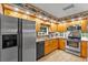 Well-lit kitchen with stainless steel appliances, granite countertops, and abundant wood cabinets at 2911 Walker Rd, Lakeland, FL 33810