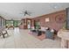 Spacious covered patio features tile flooring, a ceiling fan, and comfortable seating area at 2911 Walker Rd, Lakeland, FL 33810