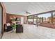 Covered patio features tile floors, a ceiling fan, seating area, and outdoor kitchen at 2911 Walker Rd, Lakeland, FL 33810