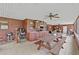 Covered patio with tile flooring, a ceiling fan, outdoor kitchen, and a picnic table at 2911 Walker Rd, Lakeland, FL 33810