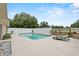 Backyard pool with stone accented lounge furniture and white vinyl fencing at 2911 Walker Rd, Lakeland, FL 33810