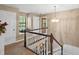 Bright foyer boasts a decorative chandelier, white staircase railing, and a window seat by the front door at 2911 Walker Rd, Lakeland, FL 33810