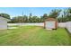 A large backyard features an in-ground pool, storage shed, and fenced yard with ample privacy at 3080 Cross Fox Dr, Mulberry, FL 33860