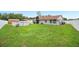 A spacious and green backyard with a home, shed, in-ground pool, and privacy fence at 3080 Cross Fox Dr, Mulberry, FL 33860