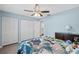 Bedroom featuring gray wood floors, pale blue walls, and a ceiling fan with a light at 3080 Cross Fox Dr, Mulberry, FL 33860