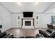 Bright living room highlighting a fireplace with a stone hearth, wooden mantle, and TV above at 3080 Cross Fox Dr, Mulberry, FL 33860
