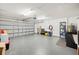 Spacious garage features an epoxy floor, and lots of room for storage and vehicles at 3080 Cross Fox Dr, Mulberry, FL 33860
