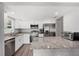 Modern kitchen features stainless steel appliances, granite countertops, and white cabinetry for a bright, updated space at 3080 Cross Fox Dr, Mulberry, FL 33860
