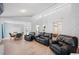 Open-concept living room with vaulted ceilings, wood floors, and comfortable seating at 3080 Cross Fox Dr, Mulberry, FL 33860