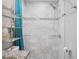 Newly renovated shower with marble and grey accent tiling and modern fixtures at 3080 Cross Fox Dr, Mulberry, FL 33860