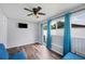Bright sunroom with wood-look floors, white walls, and a ceiling fan with a light at 3080 Cross Fox Dr, Mulberry, FL 33860