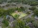 Sprawling property featuring a single-Gathering home, mature trees and ample green space outlined by a white property line at 320 W Carver St, Lakeland, FL 33805