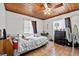 Cozy bedroom featuring wood ceilings, tile floors, and ample natural light at 320 W Carver St, Lakeland, FL 33805