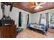 Cozy bedroom features a wood ceiling, tile floors, and bright natural light at 320 W Carver St, Lakeland, FL 33805