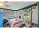 Sunroom-style bedroom with large windows offering views of the lush outdoor space at 320 W Carver St, Lakeland, FL 33805