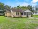 The exterior view showcases the home's roof, windows, and spacious backyard at 320 W Carver St, Lakeland, FL 33805