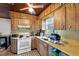 Functional kitchen boasting wood cabinets and neutral-colored countertops at 320 W Carver St, Lakeland, FL 33805
