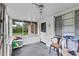 View of the enclosed porch featuring an entry door, a chair and a rack of sports balls at 320 W Carver St, Lakeland, FL 33805