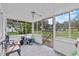 Enclosed porch featuring a tiled floor, white ceiling, and views of the surrounding yard at 320 W Carver St, Lakeland, FL 33805