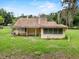 Back of the house showing windows, trim, and lawn at 320 W Carver St, Lakeland, FL 33805