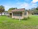A view of the back of the home showing windows and greenery at 320 W Carver St, Lakeland, FL 33805